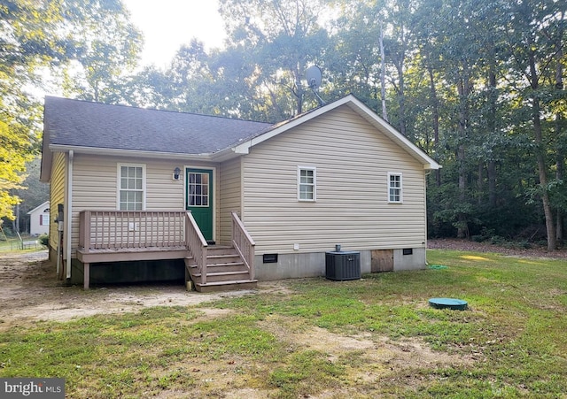 exterior space featuring a lawn, roof with shingles, crawl space, a deck, and central AC