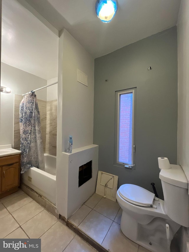 full bath featuring tile patterned floors, vanity, shower / bathtub combination with curtain, and toilet