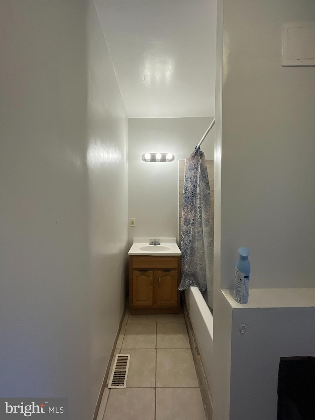 full bath featuring vanity, visible vents, shower / bath combo, and tile patterned flooring