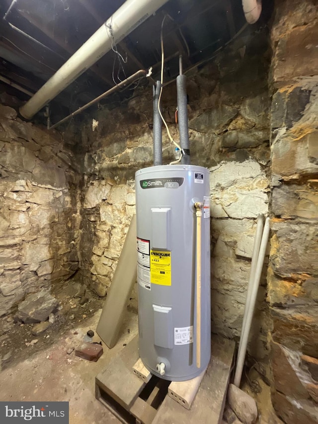 utility room featuring water heater