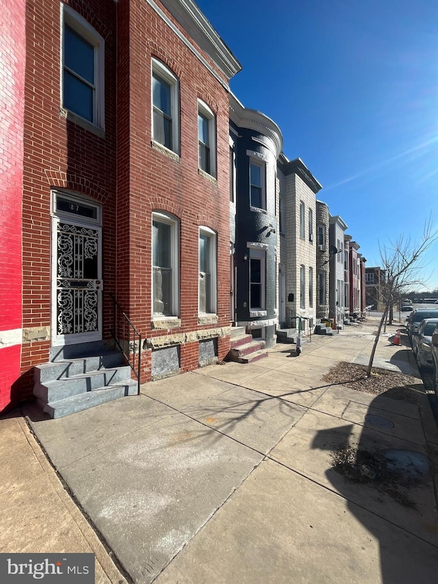 exterior space with entry steps and a residential view