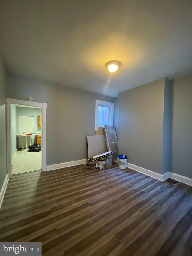 interior space featuring dark wood finished floors and baseboards