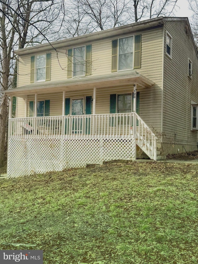 view of front of house with a front yard and covered porch