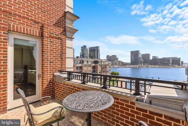 balcony with a view of city and a water view