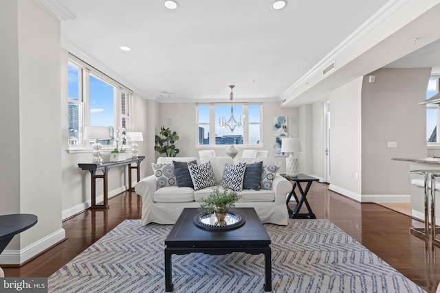 living area featuring plenty of natural light, ornamental molding, and dark wood-type flooring