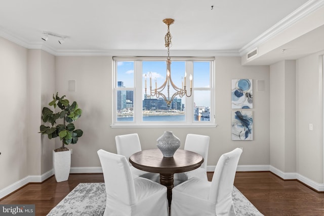 dining area featuring dark wood finished floors, visible vents, ornamental molding, a chandelier, and baseboards