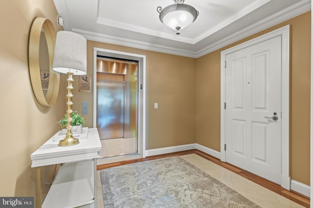 doorway to outside with elevator, baseboards, and wood finished floors