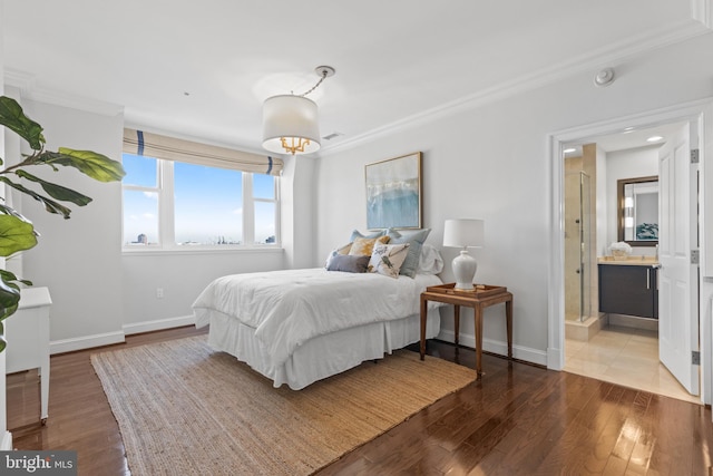 bedroom featuring baseboards, light wood finished floors, and crown molding