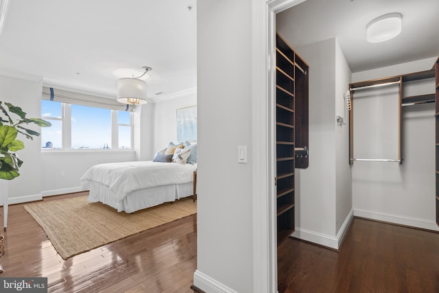 bedroom with baseboards and dark wood finished floors