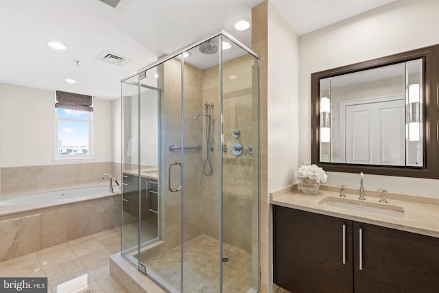 bathroom featuring tile patterned flooring, vanity, visible vents, a shower stall, and a bath