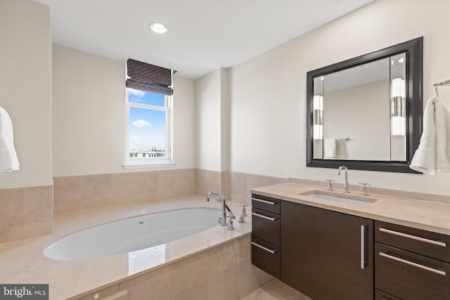 bathroom featuring a garden tub and vanity