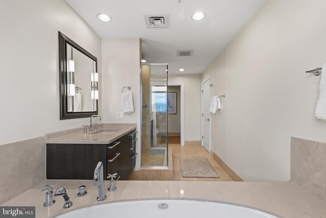 bathroom with a stall shower, visible vents, vanity, and recessed lighting