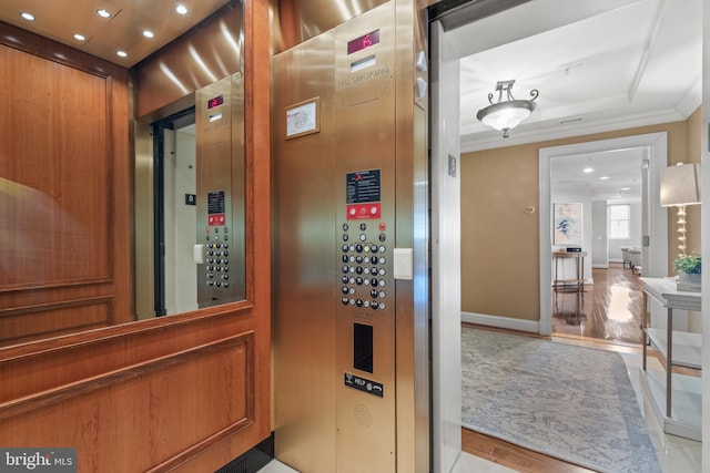 room details with baseboards, elevator, wood finished floors, crown molding, and recessed lighting