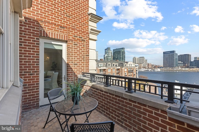 balcony featuring a city view and a water view