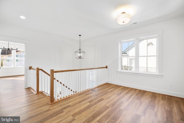 interior space featuring an inviting chandelier and hardwood / wood-style flooring