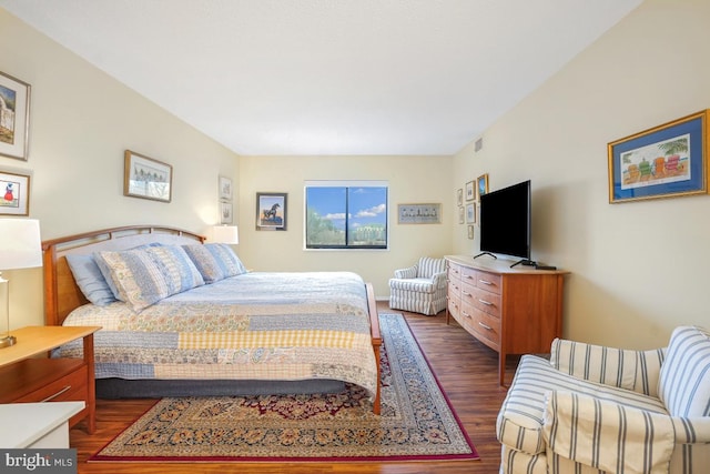 bedroom with dark wood-style floors