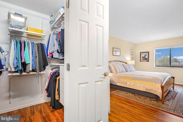 bedroom featuring a textured ceiling and wood finished floors