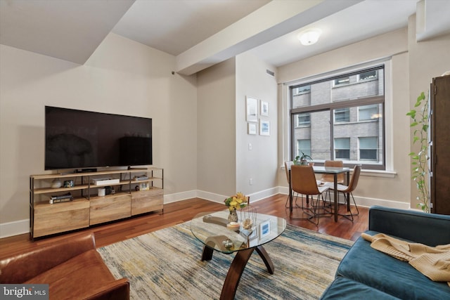 living room featuring baseboards and wood finished floors