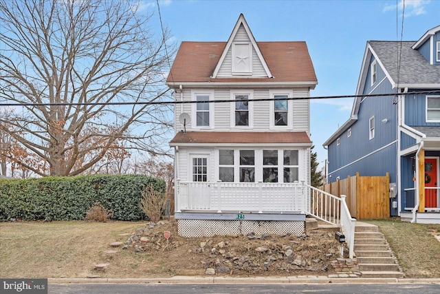 view of front of property featuring fence