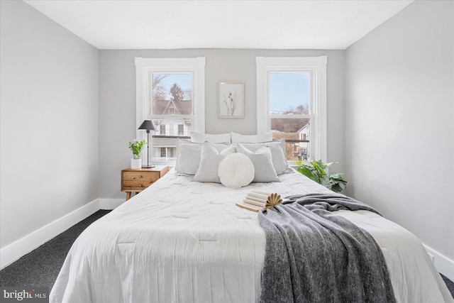 carpeted bedroom with baseboards