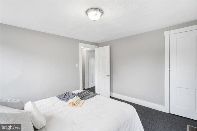 carpeted bedroom featuring visible vents, baseboards, and a textured ceiling