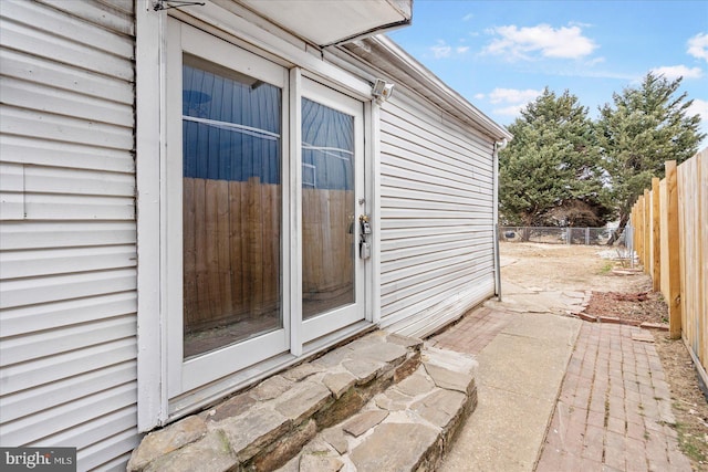 entrance to property featuring fence