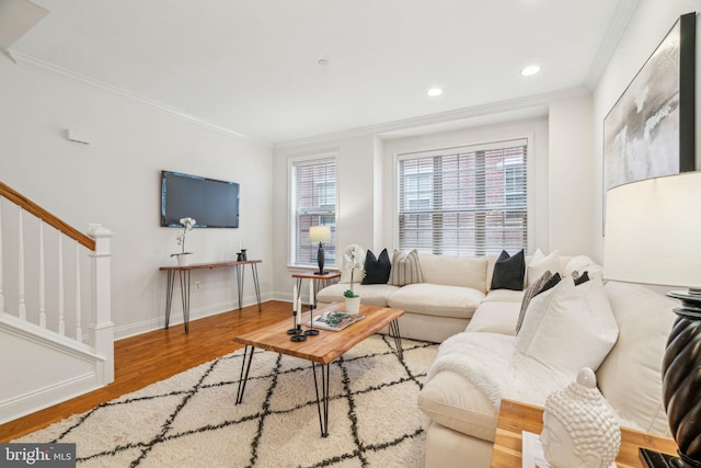 living area featuring crown molding, recessed lighting, wood finished floors, baseboards, and stairs