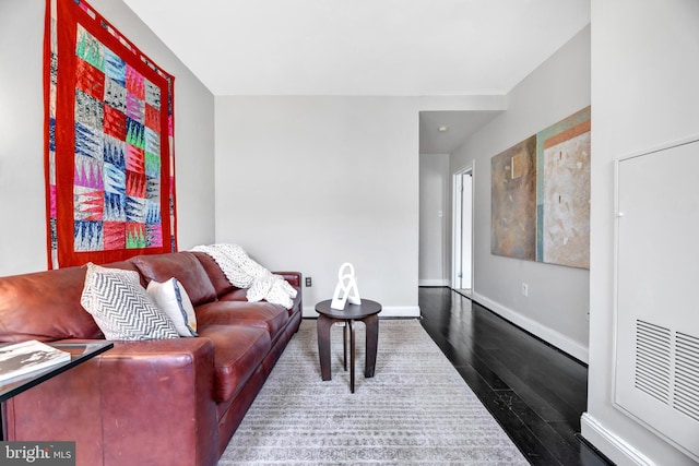 living room featuring baseboards and wood finished floors