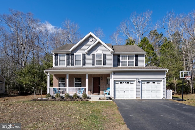 view of front of home with driveway, a garage, brick siding, a porch, and a front yard