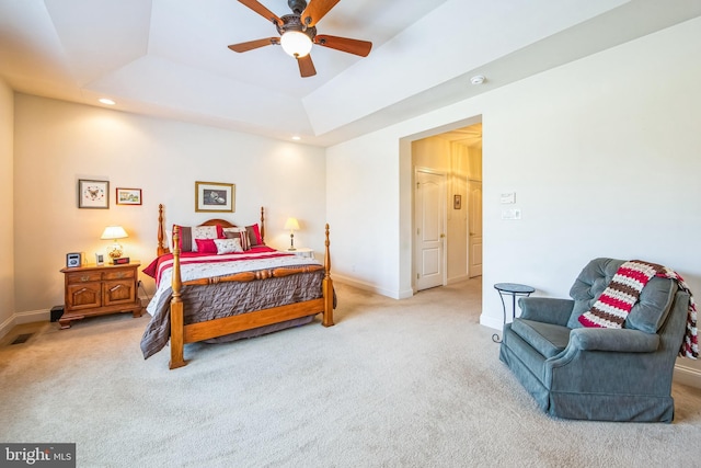 bedroom with light carpet, baseboards, a raised ceiling, visible vents, and recessed lighting