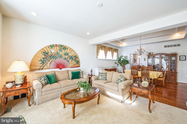 living area featuring a notable chandelier, recessed lighting, a tray ceiling, and visible vents