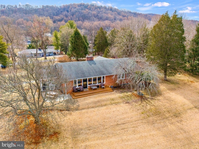 bird's eye view featuring a mountain view and a wooded view