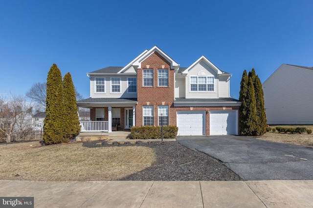 view of front facade featuring a garage, brick siding, covered porch, and aphalt driveway