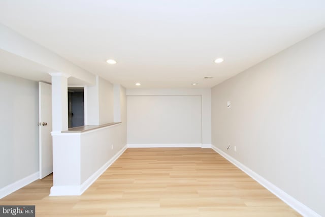 empty room with recessed lighting, baseboards, and light wood finished floors