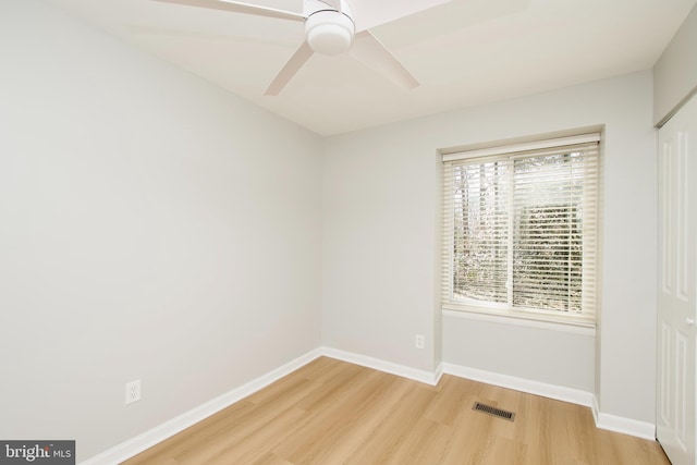 unfurnished room featuring light wood-style floors, visible vents, ceiling fan, and baseboards