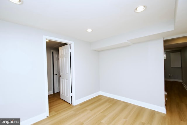 spare room featuring recessed lighting, light wood-style flooring, and baseboards