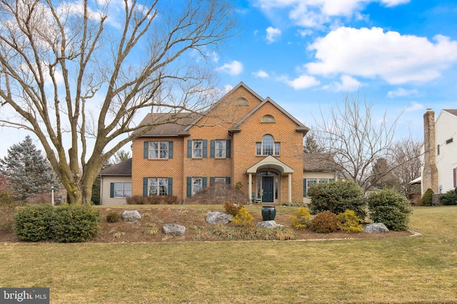 view of front of house featuring a front yard and brick siding