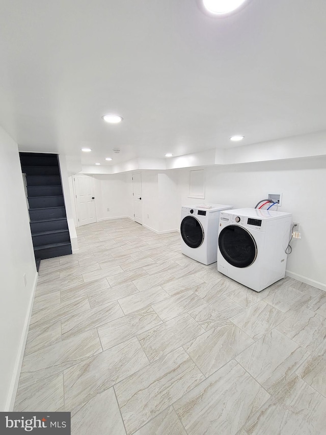 clothes washing area with washer and dryer, laundry area, baseboards, and recessed lighting