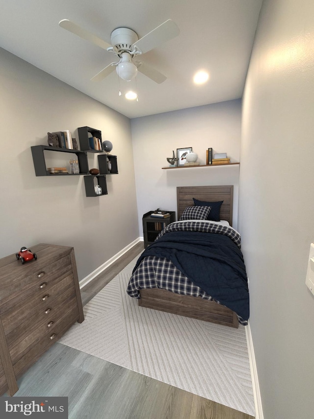 bedroom with baseboards, a ceiling fan, and wood finished floors