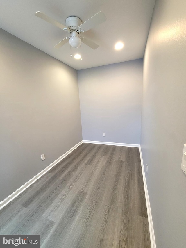 unfurnished room with a ceiling fan, baseboards, and wood finished floors