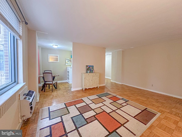 sitting room with radiator and baseboards