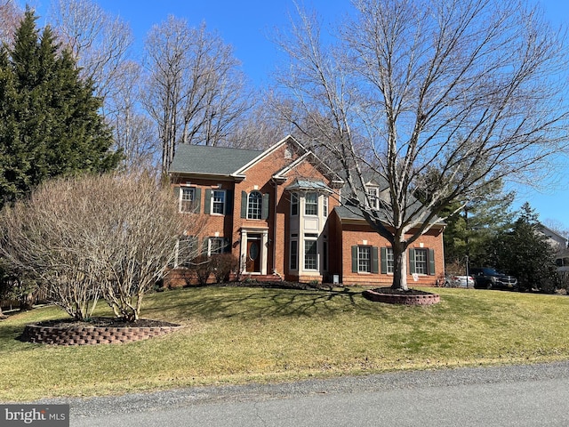 view of front of house with a front lawn and brick siding