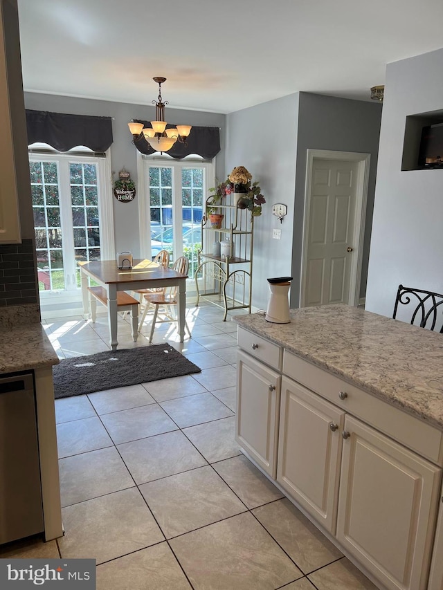 dining room with a chandelier and light tile patterned flooring