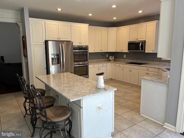 kitchen featuring light tile patterned floors, decorative backsplash, and appliances with stainless steel finishes