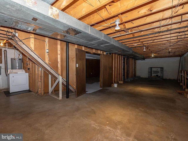 unfinished basement featuring washer / dryer and water heater