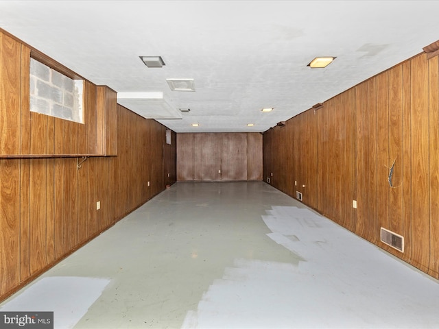 below grade area with visible vents and wooden walls