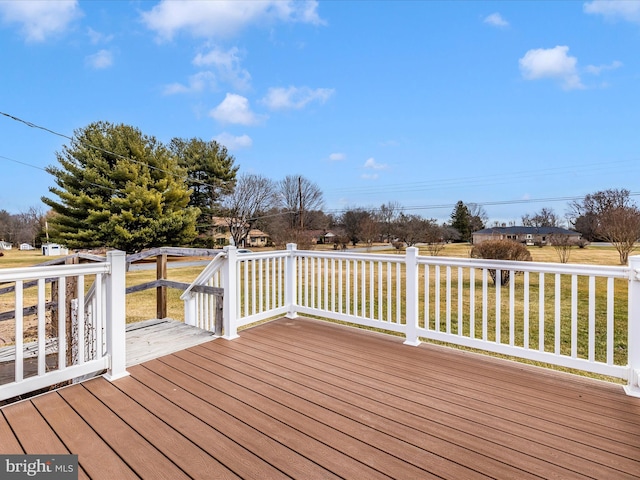 wooden deck featuring a yard