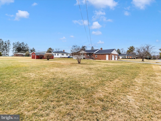 view of yard with a storage unit and an attached garage