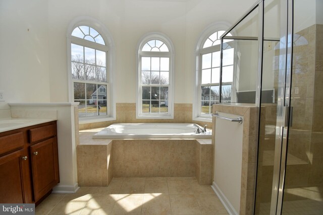 full bath with plenty of natural light, a stall shower, tile patterned flooring, and a bath