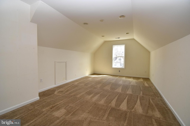 bonus room with carpet flooring, baseboards, and lofted ceiling